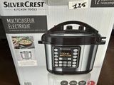 the box of a multi - use electric pressure cooker sits on a table