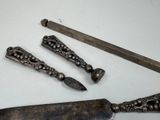 four different types of knives on a white table