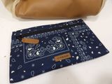 a close up of a purse and a handbag on a table