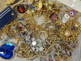a box full of gold and silver jewelry on a table