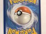 a close up of a pokemon card on a white surface