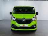 the green van is parked in a large room with white walls