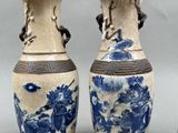 three blue and white vases sitting next to each other on a table