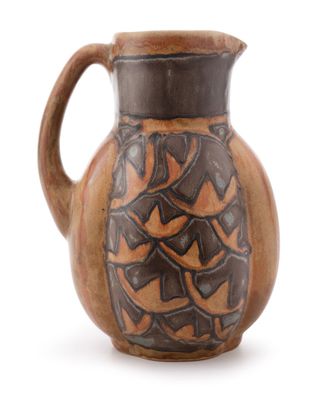 a brown and black pitcher on a white background