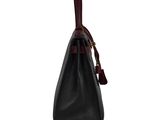 a black leather handbag with a red handle on a white background