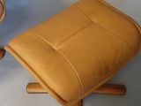 a small stool with a leather seat and a wooden base