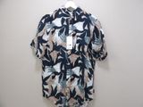 the shirt is hanging on a hanger on the wall