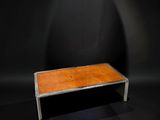 a wooden bench in a dark room with a light shining on it