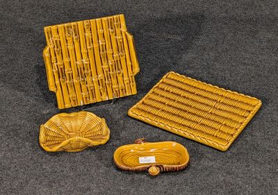 trois pièces de poterie jaune posées sur une surface noire