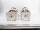 two vases are sitting on a white surface with a white background