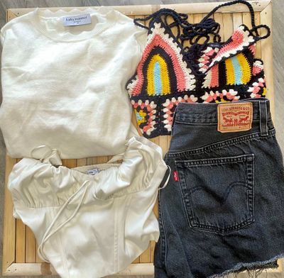 a white shirt and a pair of shorts sitting on a bamboo mat