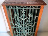 antique cast iron heat grate with wood and marble top
