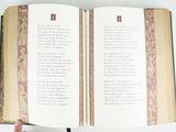 a person holding a book open with a poem on it