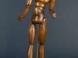 statue of a man standing on a pedestal with a stick in his hand
