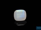 a white oplite stone on a black surface