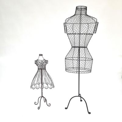 two wire mannequins and a dress form on a stand