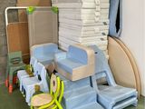 a pile of plastic chairs and a chair in a room