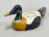 an image of a wooden duck sitting on top of a white surface