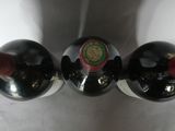 two bottles of wine that are sitting on top of each other