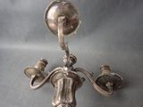 a silver candle holder with two candles on it
