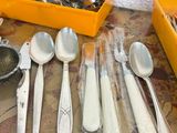 many spoons, forks, and spoon spoons on the table