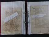 an open book with a piece of paper on top of it