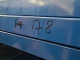 a close up of a blue metal drawer with writing on it