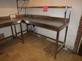 a picture of a kitchen area with a table and two benches