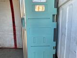 a blue door that is open in a garage