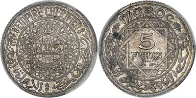 a silver coin with the number 5 on it