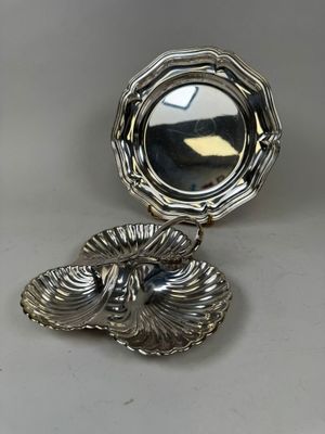 an antique silver plate with a mirror on top of it
