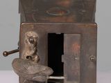 a small metal object with a bird on top of it
