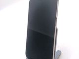 a cell phone that is on a stand on a table