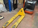 a fork and a fork lift in a warehouse