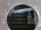 a hole in the floor that has a metal grate in it