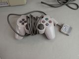 a video game controller and a charger on a table