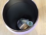 a cup with a toothbrush in it sitting on a table