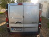 a silver van that is parked on the side of the road