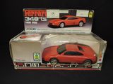 a red toy car in a box on a black background