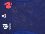 the back of a rugby shirt with a lot of signatures on it
