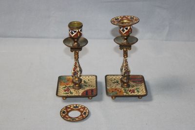 pair of antique brass candlesticks with floral designs on them