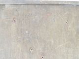 a metal box with writing on it sitting on the ground