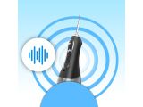 a close up of a toothbrush on a blue background with sound waves
