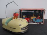 a toy car with a clown in it next to a box of toys