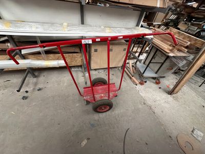 a red cart that is sitting in the middle of a room