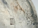 a close up of a metal object on a white surface