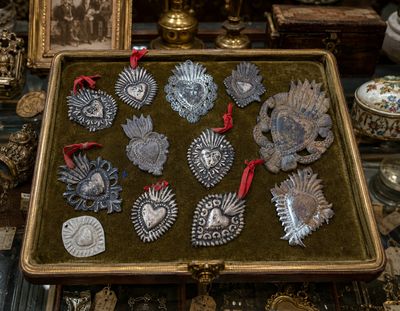 a box with a bunch of silver ornaments on it
