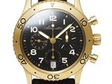 a close up of a black and gold watch on a white background
