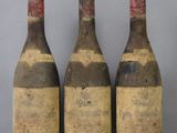three bottles of wine sitting on top of a table next to each other
