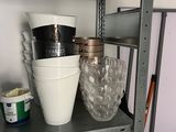 a metal shelf with cups and bowls on it